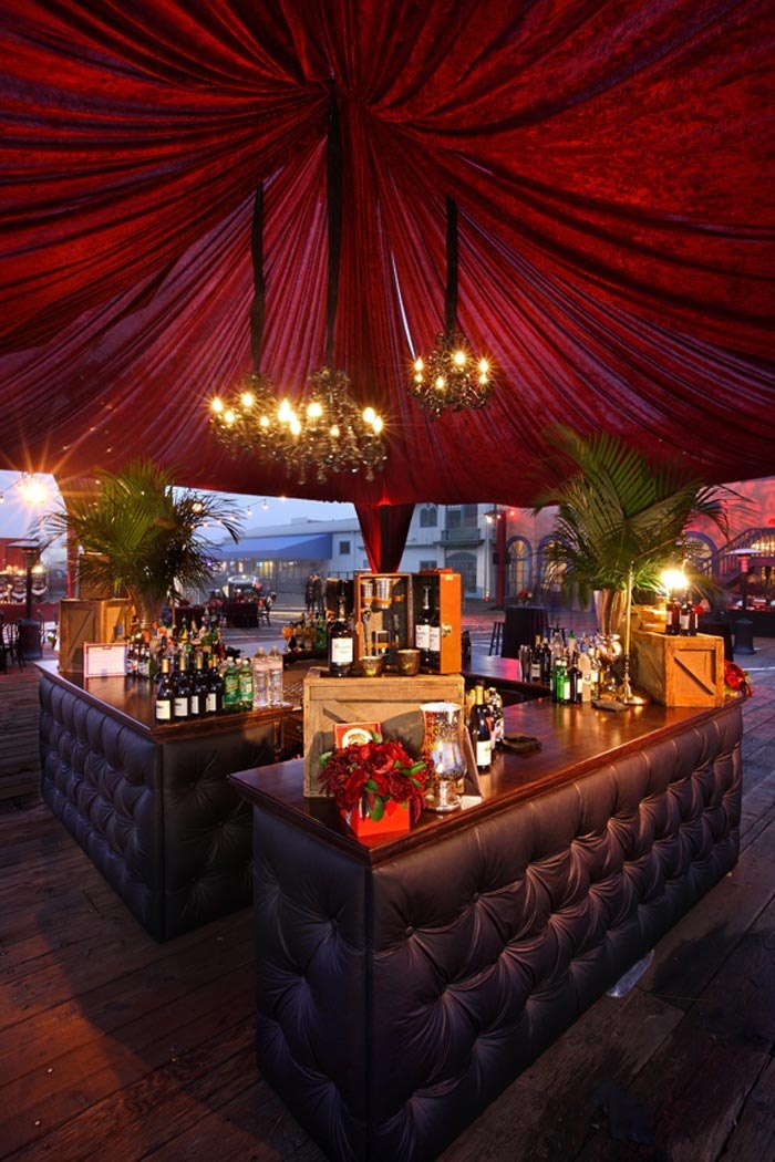 Dramatic Red Velvet Draped Central Bar – shared by BizBash