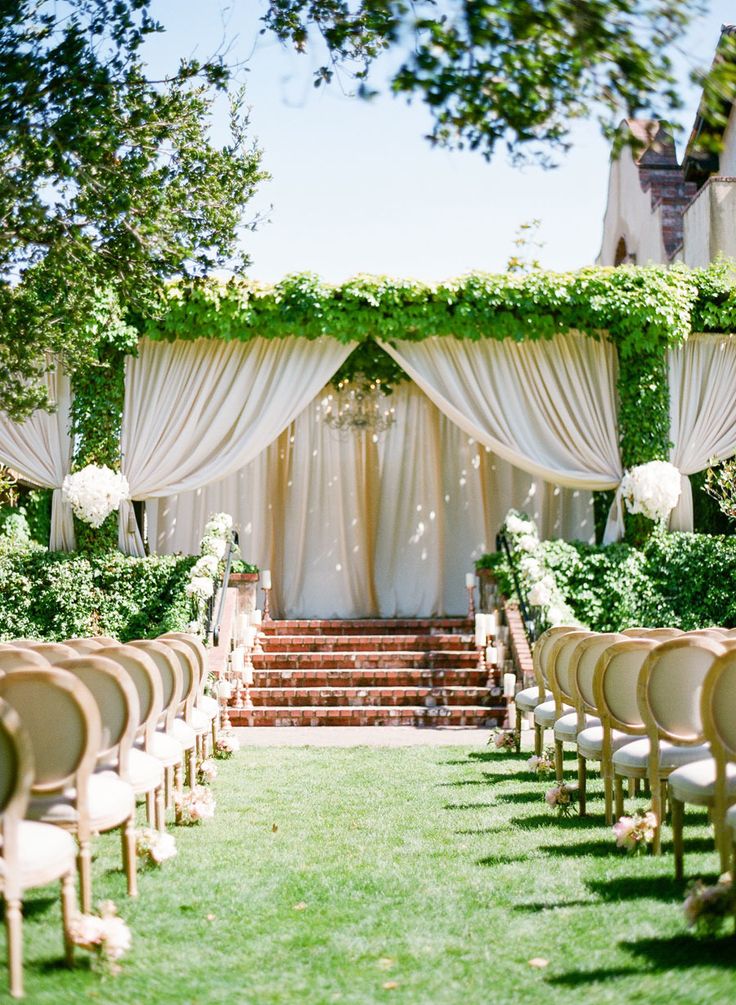 Dreamy Draped Wedding Alter with Greenery Accents – shared on Style Me Pretty