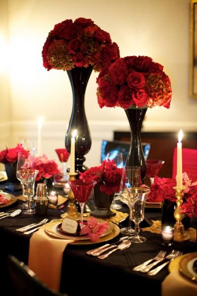 Black and Red Centerpieces with Gold Accents – shared in a roundup post by Destination Wedding Mag