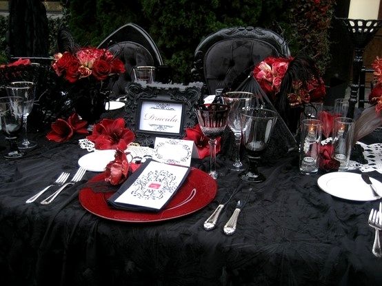 Black on Black Goth Tablescape with Red Accents – shared in a roundup post by Digsdigs