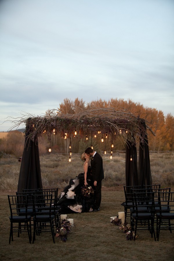 Black Wedding Altar with Rustic Branch Accents and Suspended Light Bulbs – featured on Trendy Bride