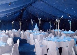 Dark Blue Tent Ceiling with White Seating and Tables – shared in a roundup by Bodas and Weddings
