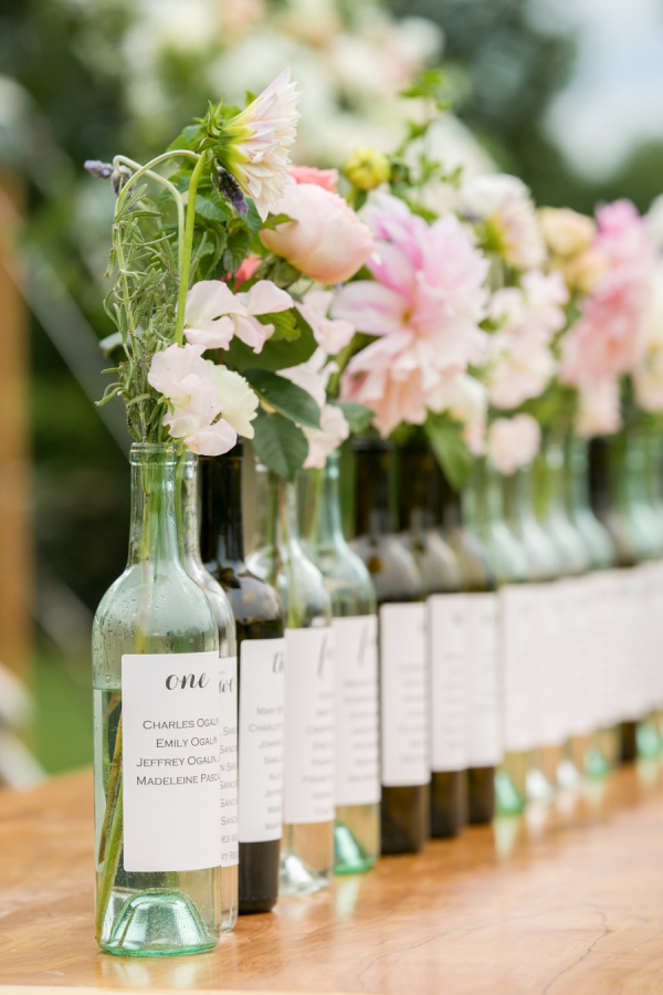 Wine Bottle Seating Charts with Spring Flowers – shared by Melani Lust Photography in the Style Me Pretty Vault