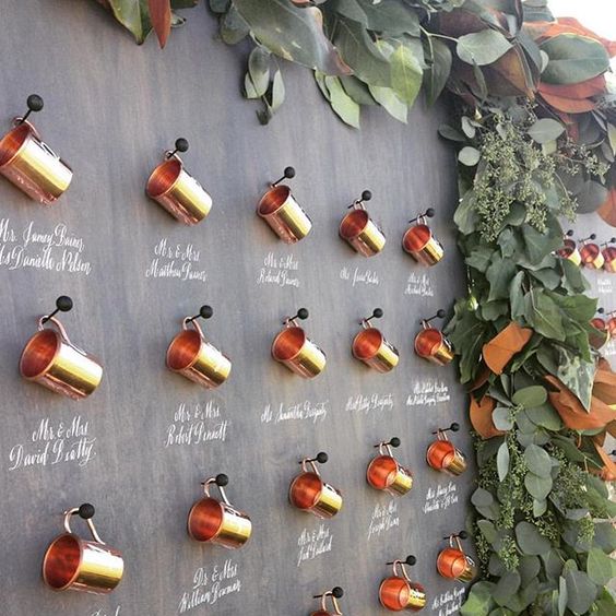 Copper Cups Display with Greenery Border