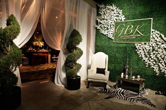 Twisted Topiary and Boxwood Entrance Wall – shared in a roundup post by BizBash