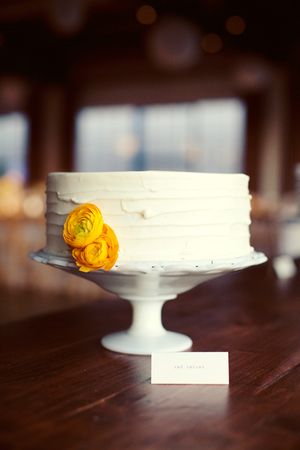 Single Tier White Textured Cake with Yellow Ranunculus Flower – created by Sugar Bee Sweets Bakery