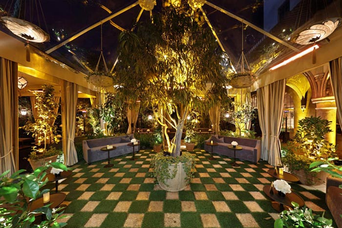 Indoor Garden Reception Lounge Seating with Foliage and Warm Lighting – share by BizBash