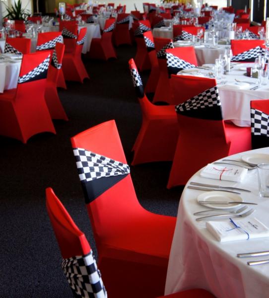 Red Spandex Chair with Checker Race Flag Accents – shared by WeddingCircle