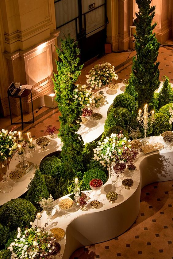 White and Green Food Buffett and Dessert Display with Wave Bars, Topiary Bushes, and Green Foliage